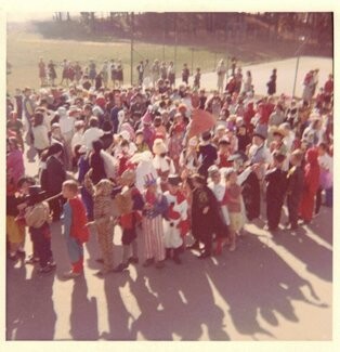 Children in Halloween costumes lined up at Ayrlawn Elementary School, 1960s